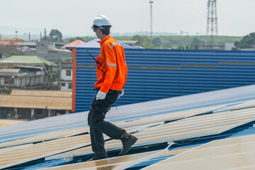 Worker Technicians are working to construct solar panels system on roof. Installing solar photovoltaic panel system. Men technicians walking on roof structure to check photovoltaic solar modules.