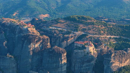 Greece Meteora region unique mountain formations and monasteries taken with drone at sunrise