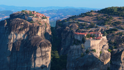 Greece Meteora region unique mountain formations and monasteries taken with drone at sunrise