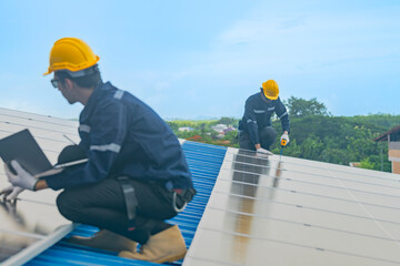 Worker Technicians are working to construct solar panels system on roof. Installing solar photovoltaic panel system. Men technicians walking on roof structure to check photovoltaic solar modules.