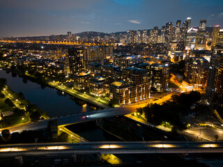 Montreal skyline illuminated at dusk and reflected in the water, Quebec, Canada