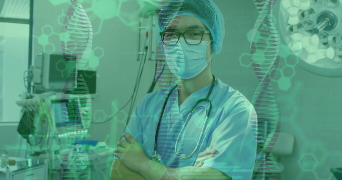 Image of data processing and dna strands over asian male surgeon with face mask