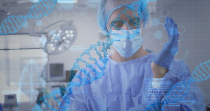 Image of data processing and dna strands over caucasian male surgeon with face mask