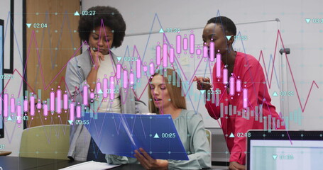 Analyzing financial data image over diverse businesswomen collaborating in office