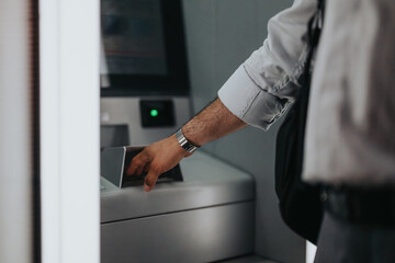 A businessperson interacting with an ATM machine for a financial transaction. This image captures the essence of modern banking and business-related activities.