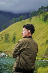 Portrait of a Southeast Asian youth enjoying the cool nature of the hills in Paropo Silalahi, North Sumatra, Indonesia