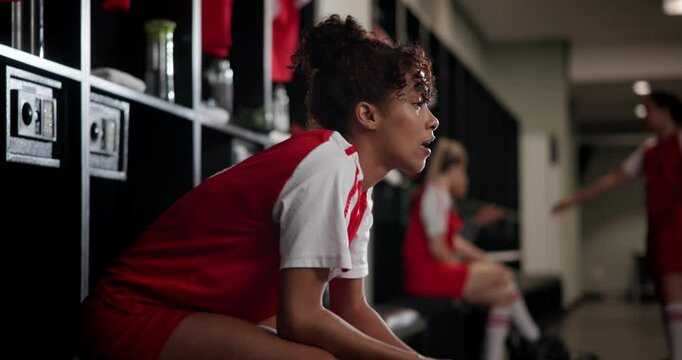Locker room, stress and woman soccer player with failure at game, training or tournament in Paris. Upset, sports and female football athlete in cloakroom thinking of mistake in match or practice. - Powered by Adobe