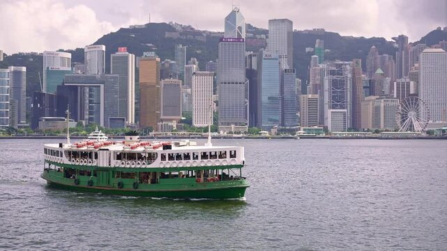 Hong Kong historic star ferry boat in Victoria Harbor, passenger ship from Kowloon island to Hong Kong. Asian modern urban center, China tourism destination.
