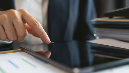 Hand touch digital tablet with blank screen for graphic display montage.