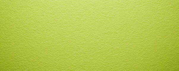 Obraz premium Lime green felt background with a smooth texture and no pattern, creating an elegant and soft backdrop perfect for adding text or images in various creative projects