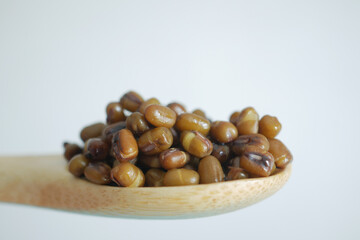 Detailed CloseUp of Freshly Cooked Mung Beans Resting Comfortably in a Wooden Spoon