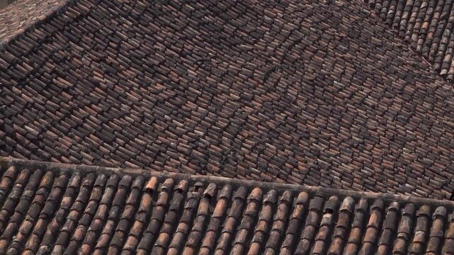 A close-up of tile shingles on a roof creating a textured background