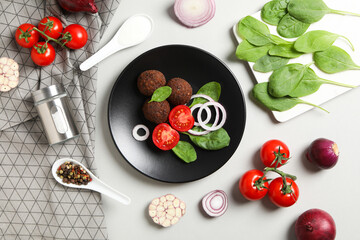 Falafel in a plate, on a light background.