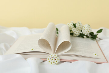 Aesthetics of books with flowers on a light background.