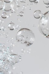 Close-up of bubbles rising in clear water on a white background.