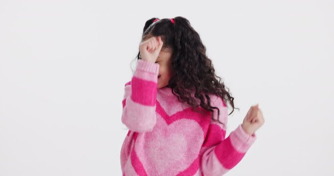 Girl, face and child with dancing in studio with smile, funny and excited for moving by white background. Kid, happy and playful with steps, comic and rhythm with fashion with confidence with culture