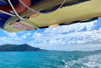 Surf rescue boat on ocean with mountain in background
