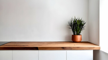 Minimalist kitchen scene with a clean wooden countertop, plant in a vase and white wall background, perfect for product presentation and mockup displays.