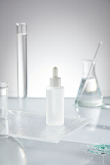 A white background and rugged platform display unlabeled serum bottles, surrounded by glass equipment laboratory with transparent solution placed on clean water surface.