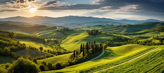 Obraz premium Sunset view over rolling hills and cypress trees in the Tuscan countryside