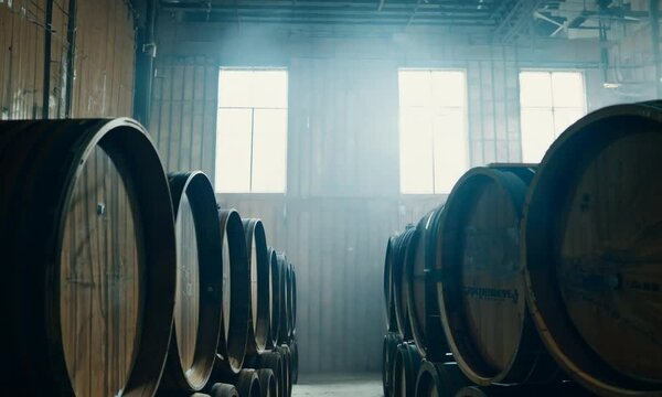 Alley of old wooden wine barrels, wine barrels stacked in warehouse