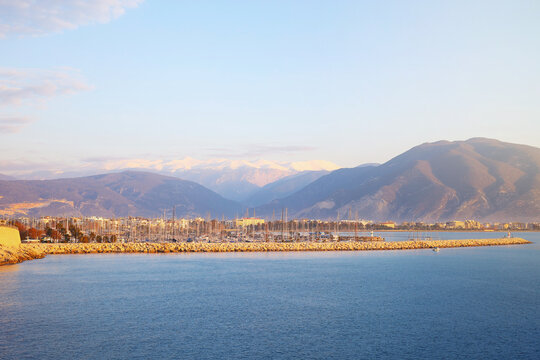 Finike marina at golden hour with snow mountains