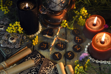 Mystic still life with runes, tarot cards and witchy ritual objects on old altar table. Occult, esoteric, wicca, Halloween and gothic concept.