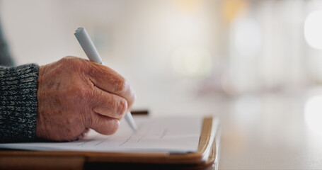 Senior person, hands and signature on will in home, insurance paperwork and plan for title deed....