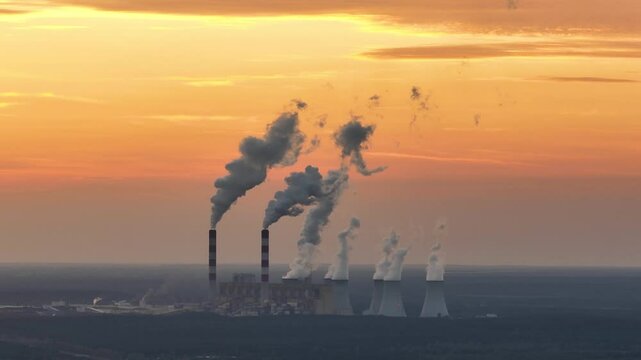 power plant against sunset sky