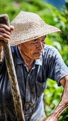 Amid the summer heat, a farmer grips a hoe, ready to till the land, sweat glistening as he works hard under the sun.