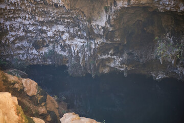 Rocky cave entrance with dark water