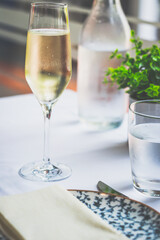 a glass of sparkling prosecco on a table with a white table cloth