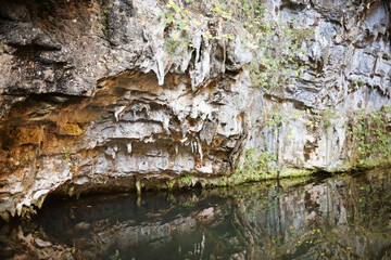 Rocky cliffside reflected in water