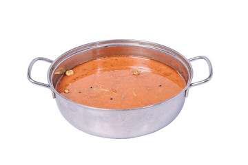  A round metal pot filled with a simmering broth, with visible ingredients and spices.