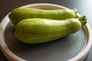  Two Fresh Zucchini on the Table Close-Up