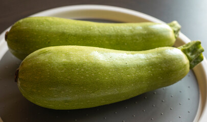  Two Fresh Zucchini on the Table Close-Up