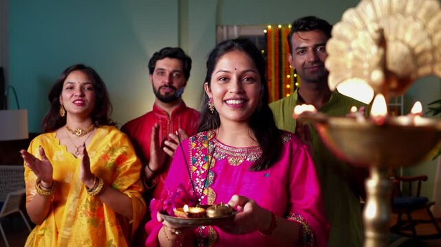Indian family of four sings aarti and seeking blessings of Ganapati Bappa in beautifully adorned home surrounded by samai and embracing the spirit of devotion and togetherness