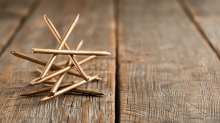Visual representation of hierarchical structure in a company, with a topdown format using gold wires and nails on wooden surface. Shallow DOF.