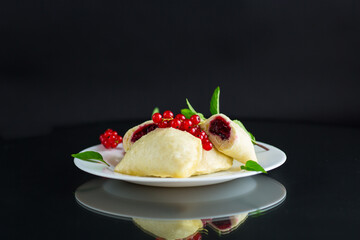 steamed sweet homemade dumplings with berries, red currants