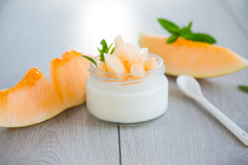 sweet homemade yogurt in a jar with pieces of ripe melon