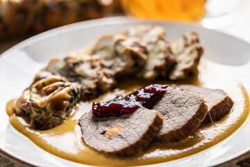 Beef fillets from sirloin steak with traditional Czech sauce, Karlovy Vary dumpling with cranberries and good Czech beer