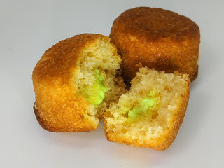 Close-up of mini cupcakes with green frosting, isolated on a white background.