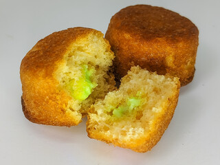 Close-up of mini cupcakes with green frosting, isolated on a white background.