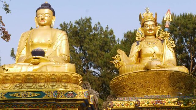 Huge statues of prominent figures of Buddhism known as Gautama Buddha and Rinpoche Padmasambhava infront of Swayambhunath Stupa.