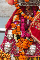 The altar of Goddess Durga is decorated with flowers and red clothes