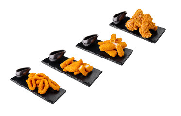 Deep fried appetizers served with dipping sauce on black stone platters