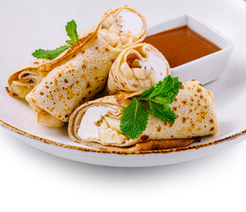 Pancakes with cottage cheese and banana slices lying on white plate