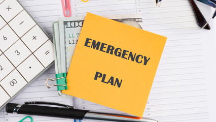 Conceptual emergency plan symbol. Copy space. Emergency plan words written on a yellow sticker on top of dollar bills