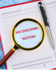 Conceptual no discrimination symbol. Copy space. No discrimination words written in an open notebook through a magnifying glass, top view