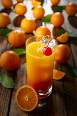 Classic tequila sunrise cocktail on an old wooden table.